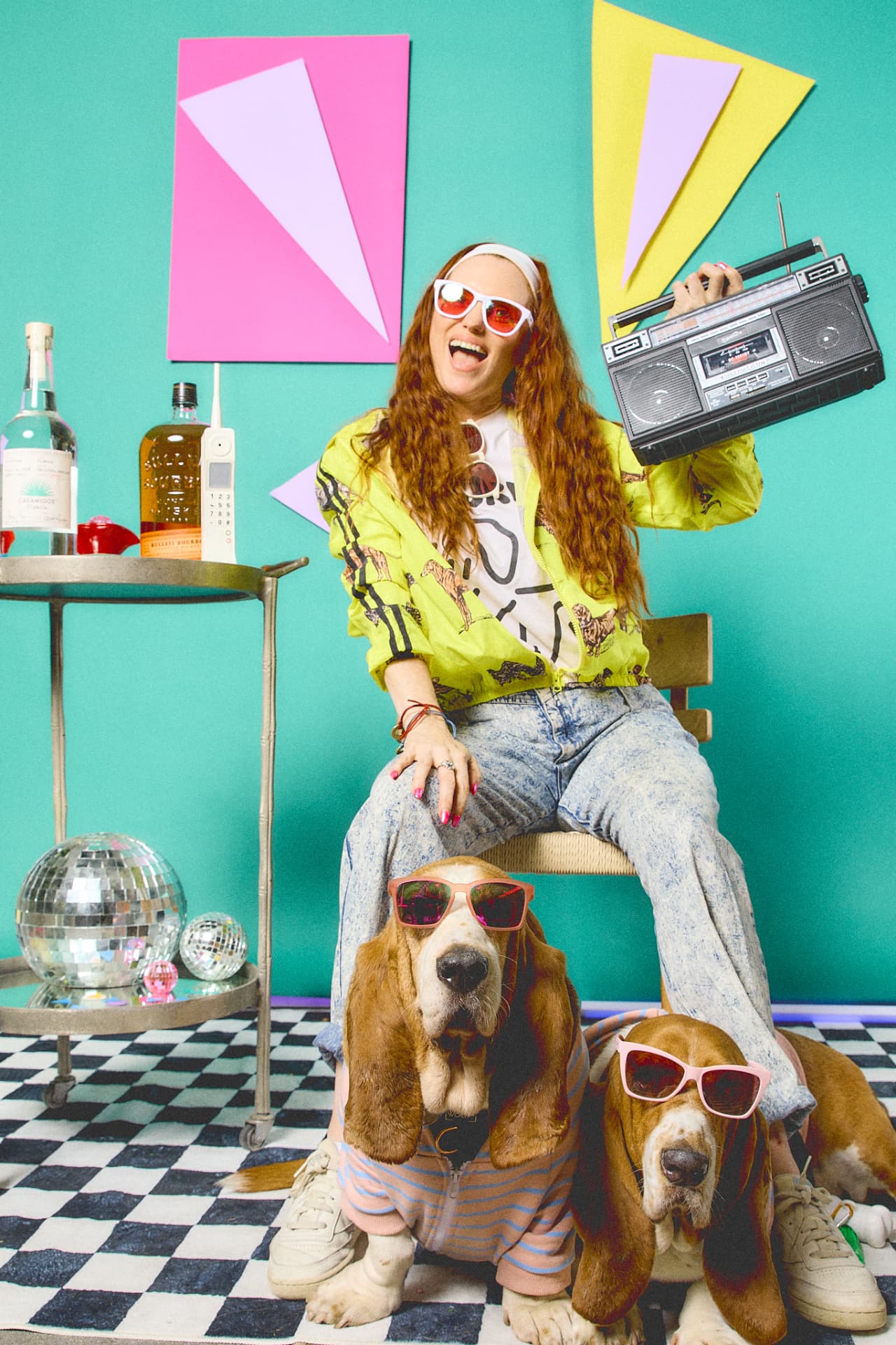 Pet parent with a boombox and two basset hounds in sunglasses