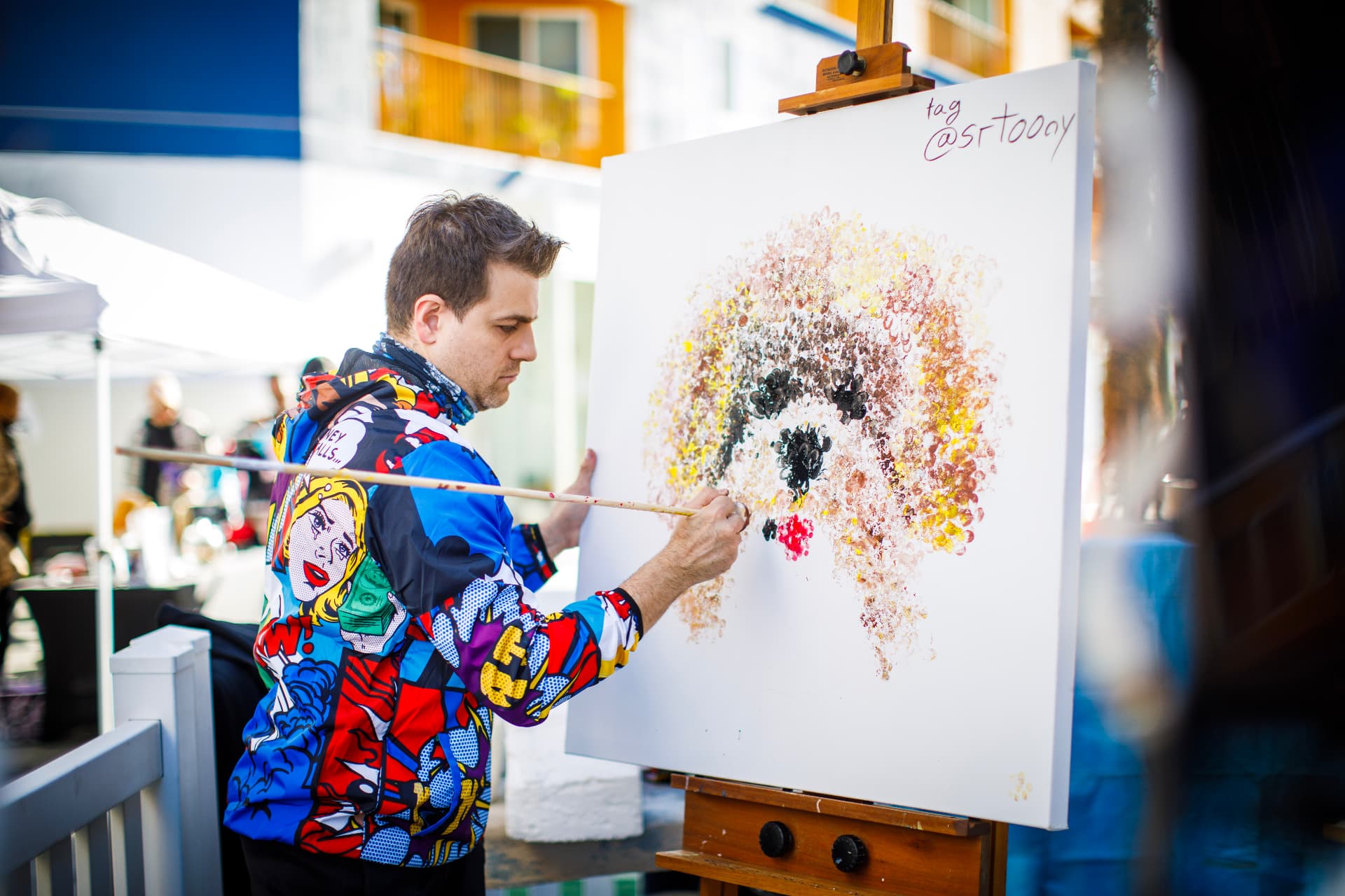Artist @srtoony painting a pointillist portrait of a poodle on canvas